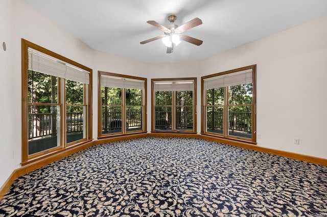 unfurnished sunroom with a healthy amount of sunlight and ceiling fan