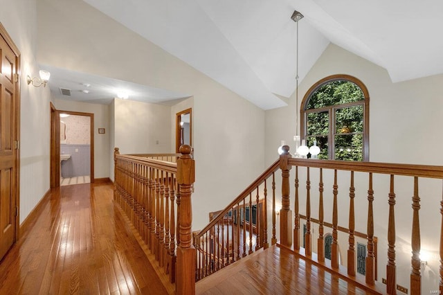 corridor featuring high vaulted ceiling and hardwood / wood-style floors