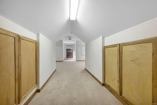 additional living space with vaulted ceiling and light colored carpet