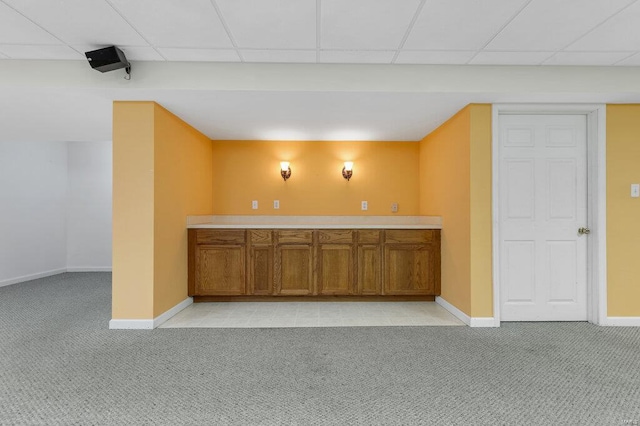 bar with light colored carpet and a drop ceiling