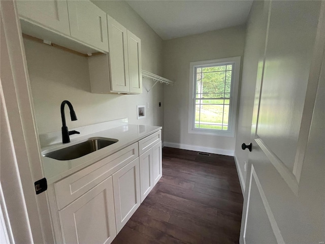 kitchen featuring sink, dark wood-type flooring, and white cabinets