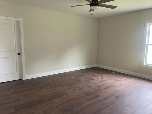 unfurnished room with dark hardwood / wood-style flooring and ceiling fan