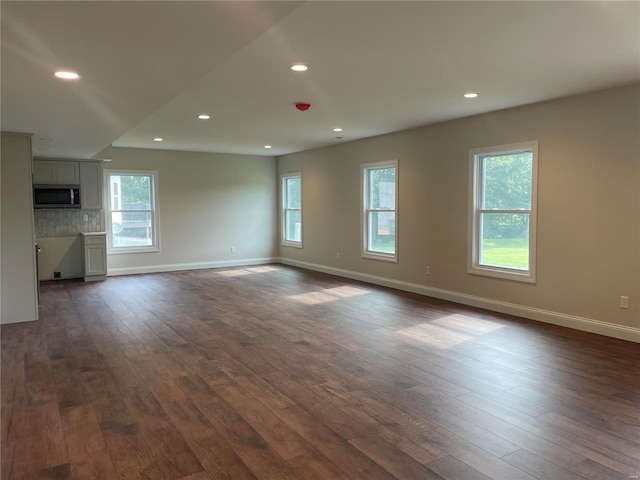 unfurnished living room with wood-type flooring