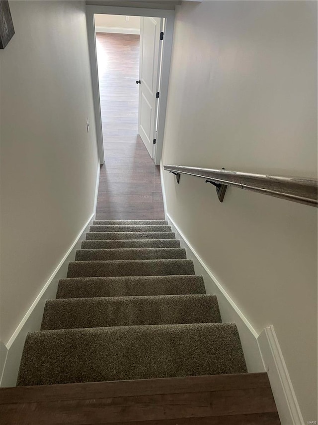 stairway featuring hardwood / wood-style flooring