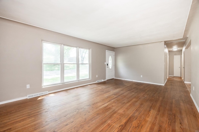 unfurnished living room featuring dark wood-type flooring