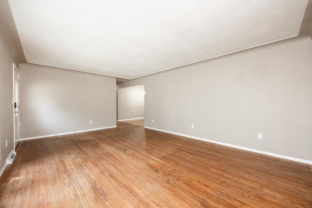 empty room with hardwood / wood-style floors