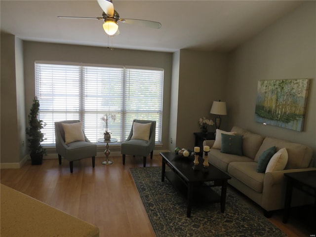 living room featuring wood-type flooring and ceiling fan