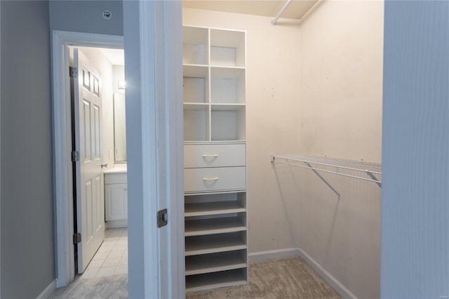 spacious closet featuring light tile patterned floors