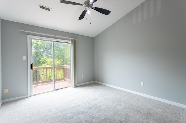 unfurnished room featuring carpet, visible vents, vaulted ceiling, and baseboards