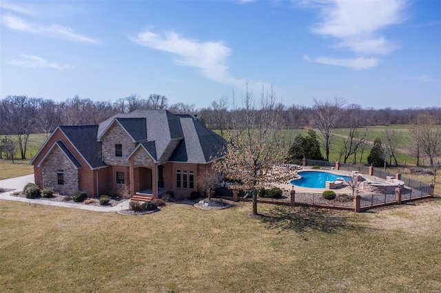 exterior space with a fenced in pool, fence, roof with shingles, stone siding, and a lawn