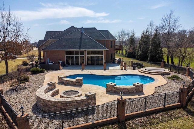 view of pool with a hot tub, a fenced backyard, an outdoor fire pit, a sunroom, and a patio area