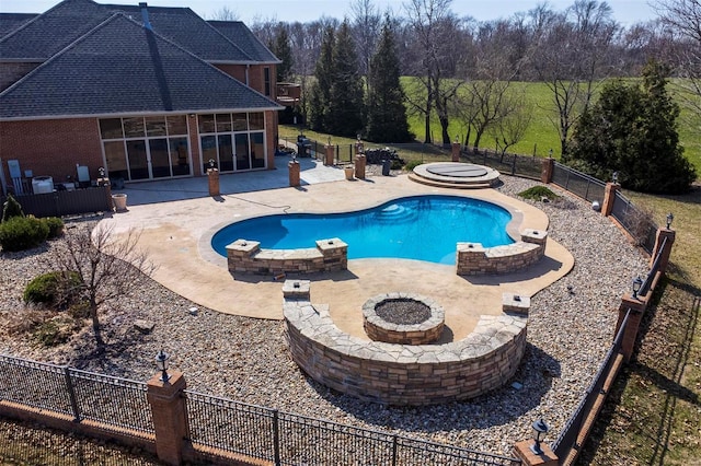 view of swimming pool featuring a patio, a fenced in pool, an outdoor fire pit, a fenced backyard, and a sunroom