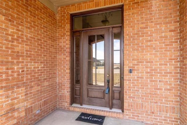 property entrance with brick siding