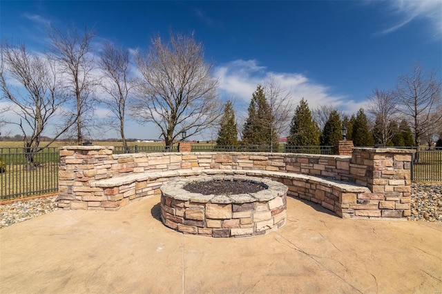 view of patio / terrace with an outdoor fire pit and fence