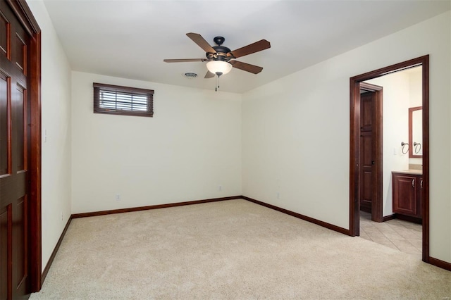 unfurnished room with visible vents, a ceiling fan, baseboards, and light carpet