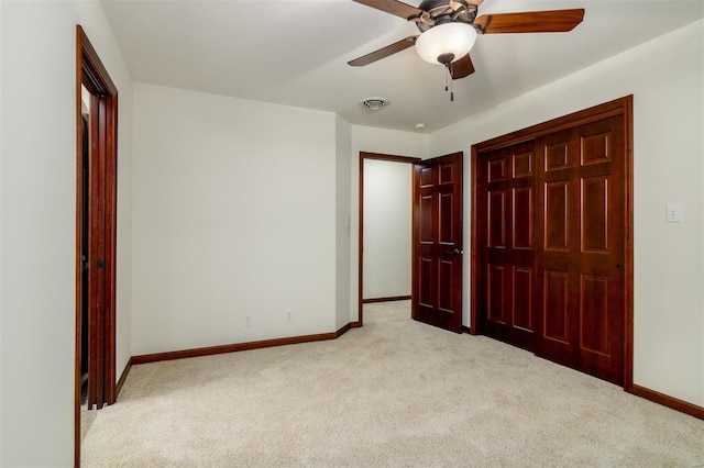 unfurnished bedroom with light colored carpet, visible vents, and baseboards