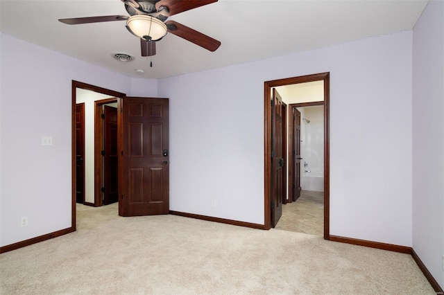 unfurnished bedroom with visible vents, light colored carpet, connected bathroom, and baseboards