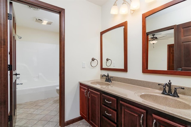 full bath featuring a sink, toilet, double vanity, and tile patterned floors