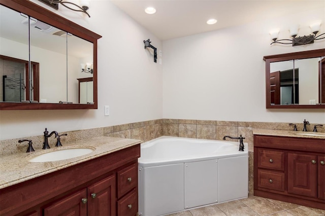 bathroom featuring two vanities, a bath, recessed lighting, and a sink