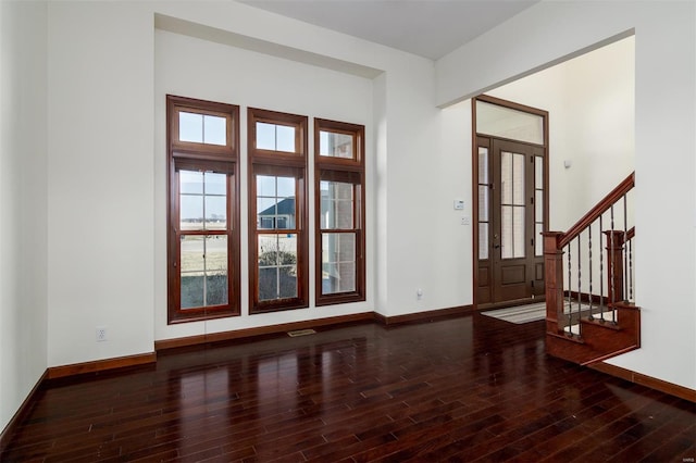 entrance foyer featuring baseboards, wood finished floors, and stairs