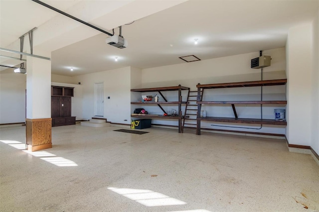 garage with a garage door opener and baseboards