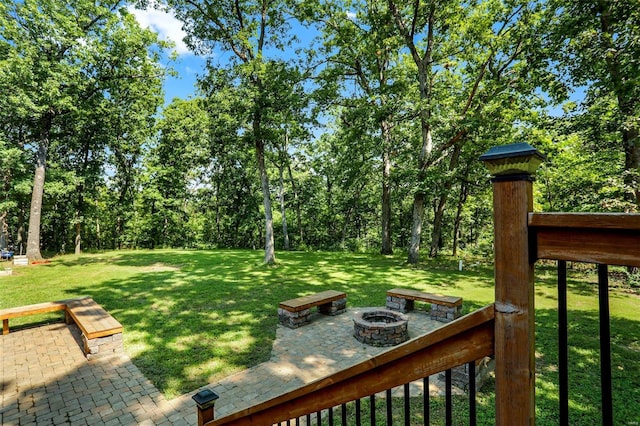 view of yard featuring a patio and an outdoor fire pit