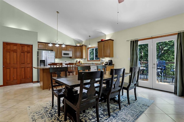 dining area with ceiling fan, lofted ceiling, light tile patterned floors, and french doors