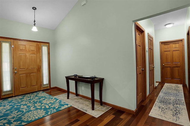 entrance foyer featuring lofted ceiling and dark hardwood / wood-style floors