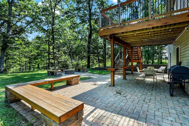 view of patio with a deck, area for grilling, and an outdoor fire pit