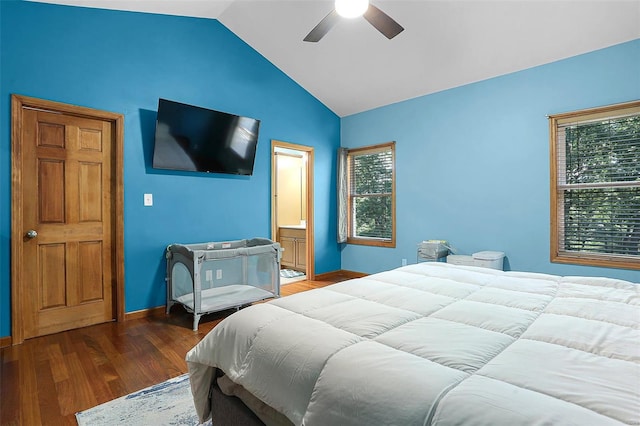 bedroom featuring vaulted ceiling, dark hardwood / wood-style floors, ceiling fan, and ensuite bath