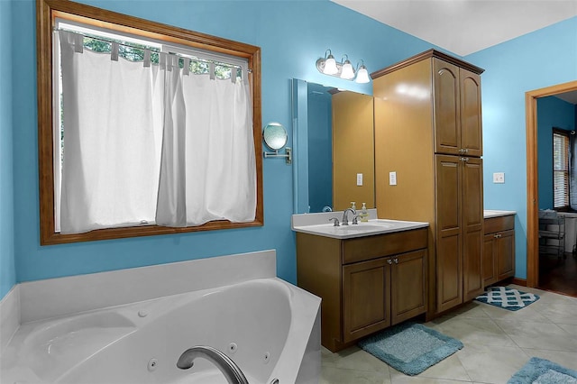 bathroom featuring a bathtub, tile patterned flooring, and vanity