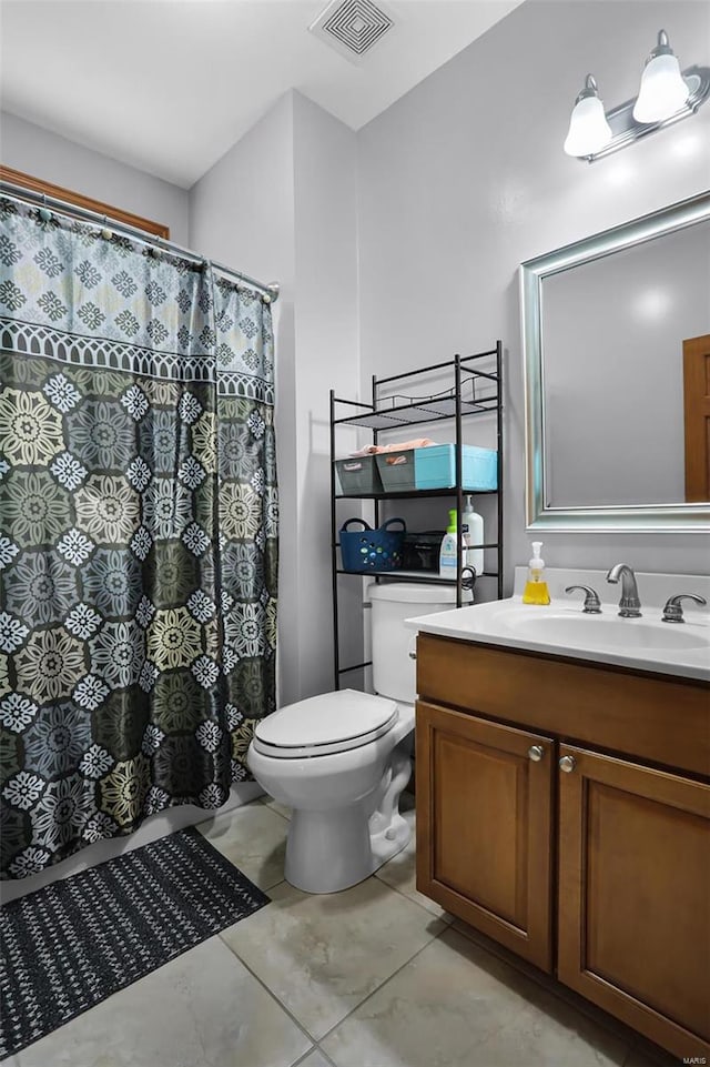 bathroom featuring curtained shower, vanity, and toilet