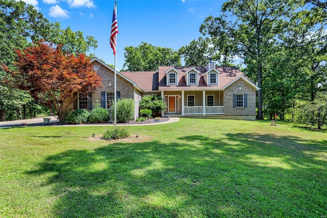 cape cod house with a front lawn and a porch