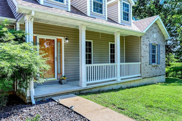 entrance to property with a yard and a porch