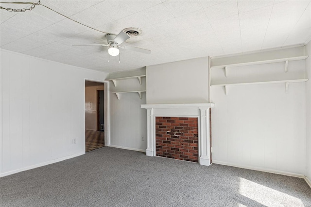 unfurnished living room featuring carpet floors, visible vents, a fireplace, and a ceiling fan