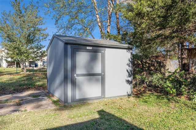 view of shed featuring fence