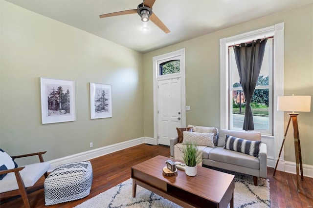 living room featuring ceiling fan and dark hardwood / wood-style flooring