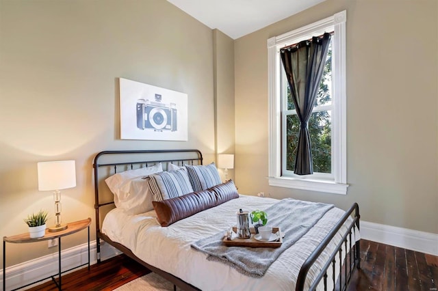 bedroom featuring a baseboard radiator and dark hardwood / wood-style flooring