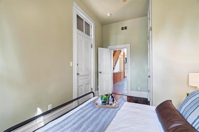 bedroom with dark hardwood / wood-style floors