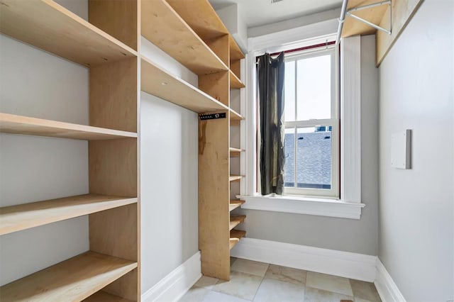 spacious closet featuring light tile patterned floors