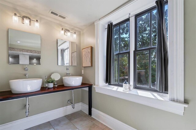 bathroom featuring tile patterned flooring and vanity