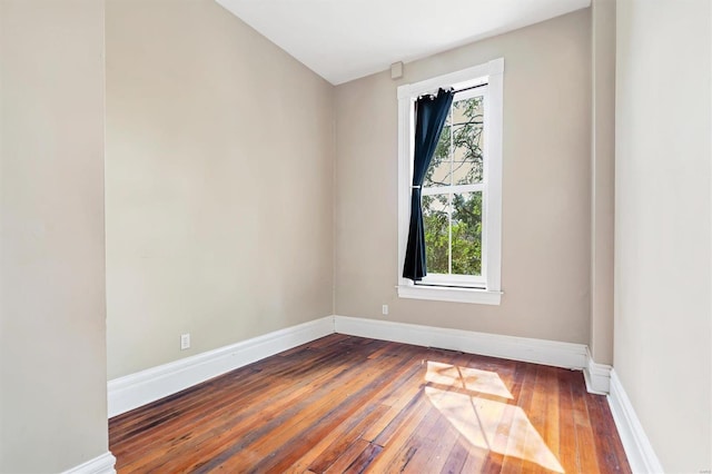 spare room featuring hardwood / wood-style floors and a healthy amount of sunlight