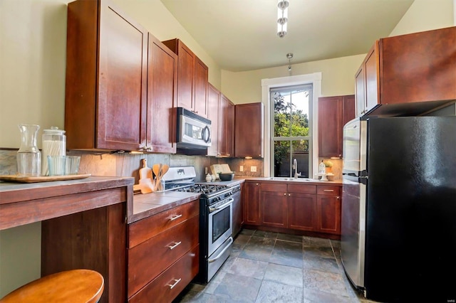 kitchen featuring tasteful backsplash, stainless steel appliances, and sink