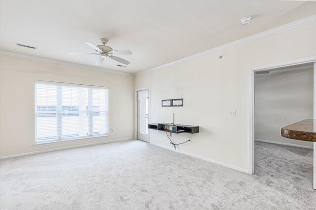 unfurnished living room with ceiling fan, carpet flooring, and ornamental molding