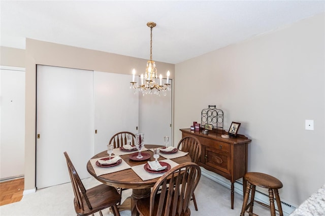 dining space featuring light parquet flooring and a chandelier