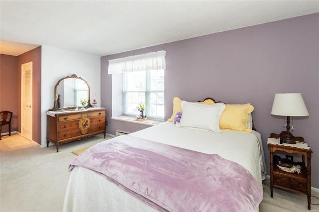 carpeted bedroom with a baseboard radiator