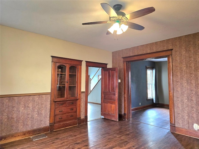 spare room featuring dark hardwood / wood-style floors and ceiling fan