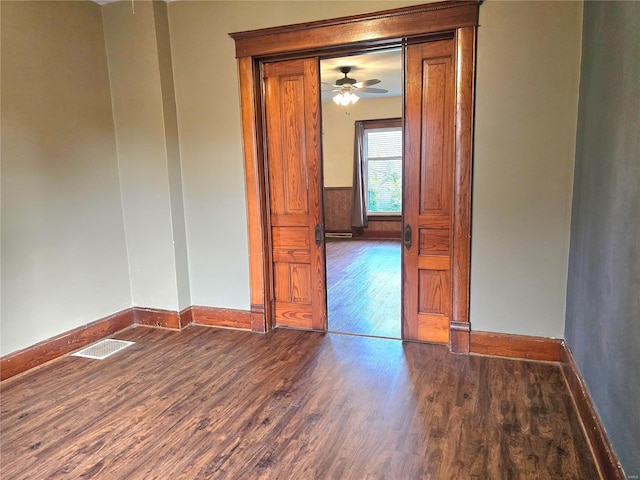 spare room featuring ceiling fan and dark hardwood / wood-style flooring