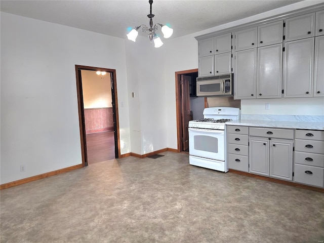 kitchen featuring hanging light fixtures, white gas range oven, a notable chandelier, gray cabinets, and a textured ceiling