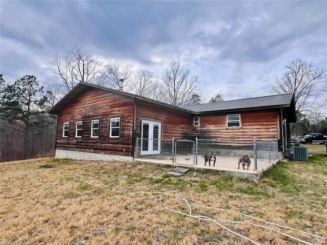 back of house featuring a lawn, french doors, and central air condition unit